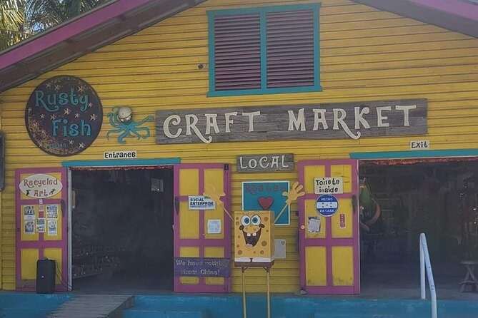 A craft market in a building painted yellow, pink and blue